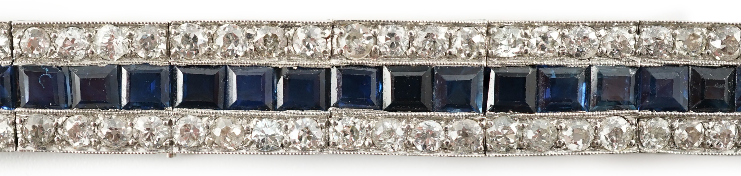 A 1920’s white gold, sapphire and diamond set triple line bracelet